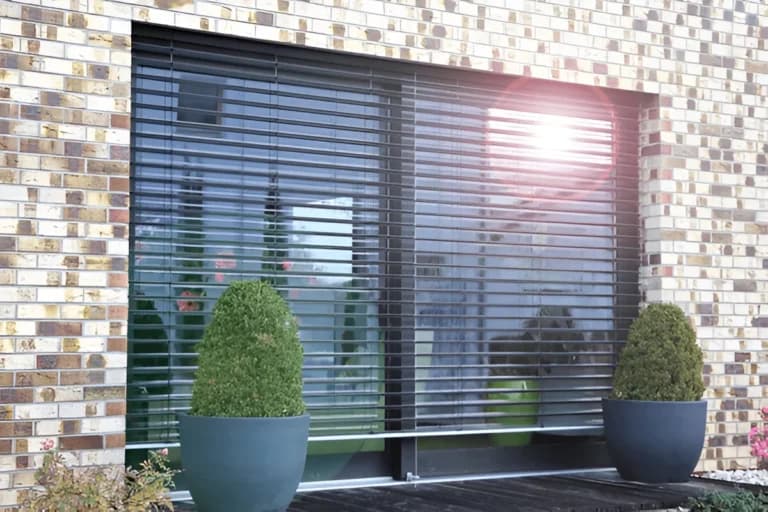 Bright living room window fitted with a blind screen