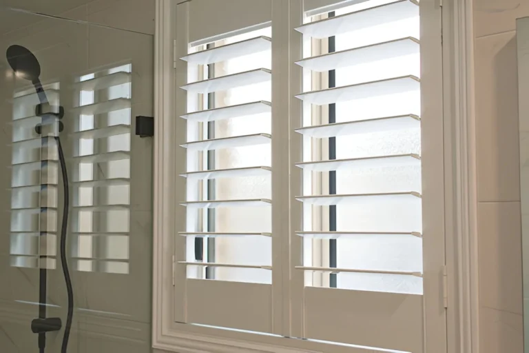 White plantation shutters fitted to a bathroom window